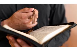 person-holding-holy-book-rosary -1-.jpg